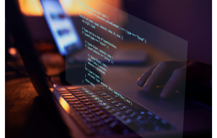 Computer coding above a keyboard showing an audit file system