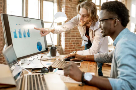 Two people in a meeting discussing job workflow management